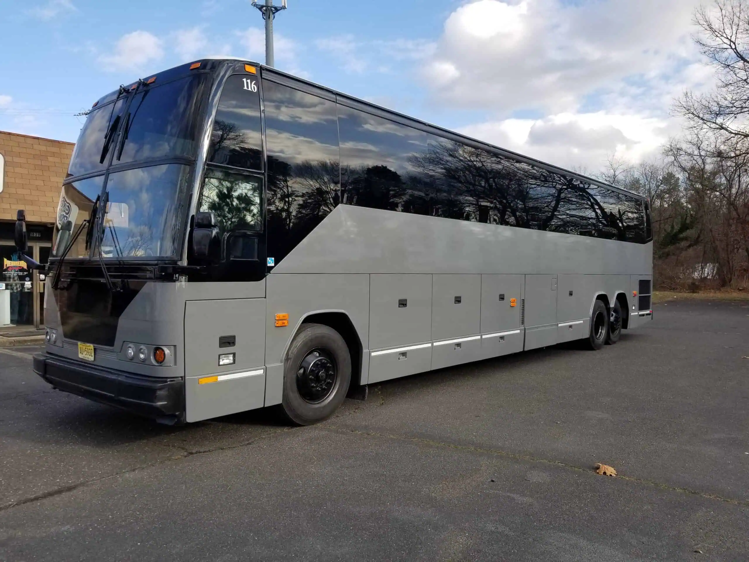 55 Passenger Coach Bus Exterior wedding shuttle NJ — premium leather seating, USB charging, Bathroom on Board.
